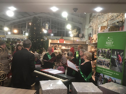 people singing christmas carols for charity